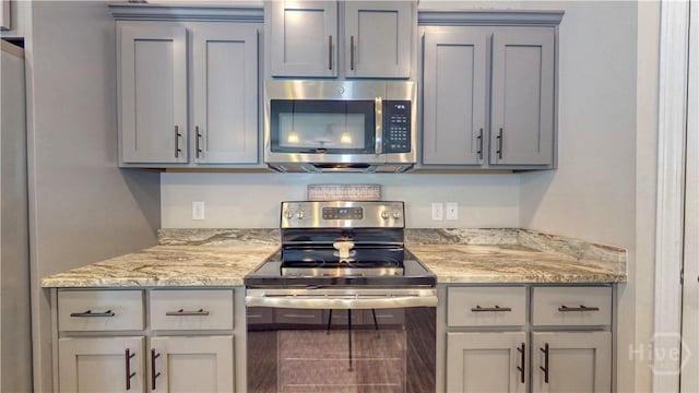 110 Tailwind Trl, Guyton, GA 31312 - kitchen with appliances with stainless steel finishes, gray cabinets, and light stone countertops