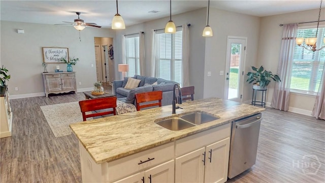 110 Tailwind Trl, Guyton, GA 31312 - kitchen featuring dishwasher, open floor plan, wood finished floors, a center island with sink, and white cabinetry