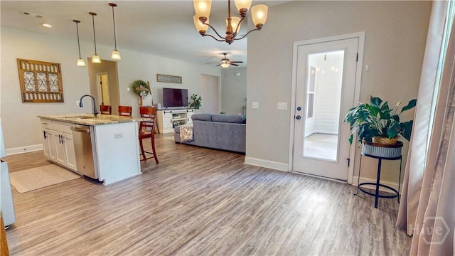 110 Tailwind Trl, Guyton, GA 31312 - kitchen featuring dishwasher, a kitchen bar, white cabinetry, and light wood-type flooring