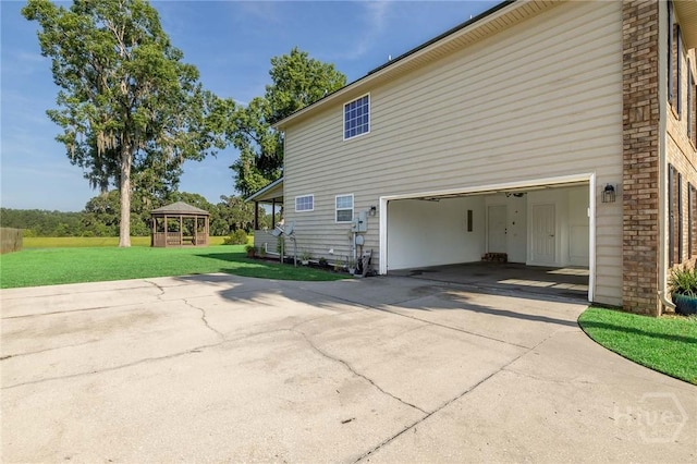 9 Sweetwater Ct, Savannah, GA 31419 - view of home's exterior with a gazebo, concrete driveway, a lawn, and brick siding