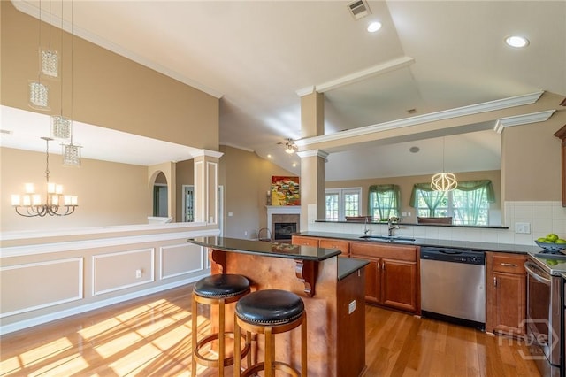 9 Sweetwater Ct, Savannah, GA 31419 - kitchen featuring dishwasher, brown cabinets, electric range oven, a breakfast bar, and a fireplace