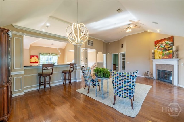 9 Sweetwater Ct, Savannah, GA 31419 - dining area featuring lofted ceiling, a ceiling fan, ornate columns, a glass covered fireplace, and wood finished floors