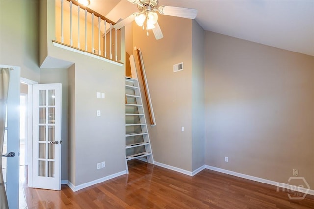 9 Sweetwater Ct, Savannah, GA 31419 - empty room with ceiling fan, high vaulted ceiling, wood finished floors, and stairway