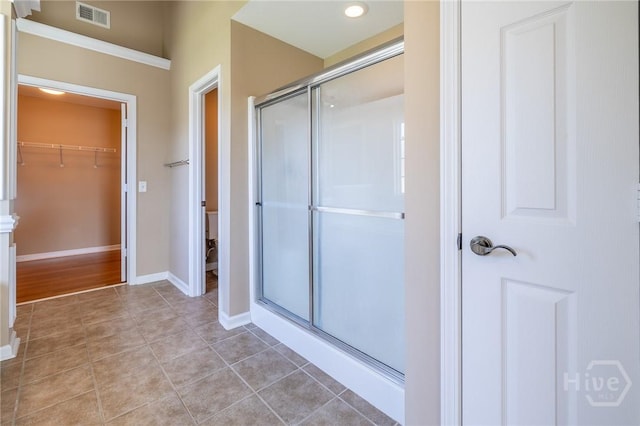 9 Sweetwater Ct, Savannah, GA 31419 - bathroom featuring a stall shower, a spacious closet, and tile patterned flooring