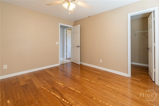 9 Sweetwater Ct, Savannah, GA 31419 - unfurnished bedroom featuring light wood-style flooring, a walk in closet, a closet, and a ceiling fan