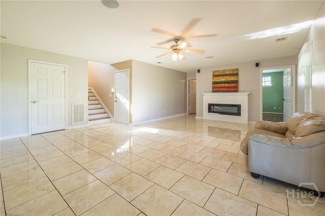 9 Sweetwater Ct, Savannah, GA 31419 - living area with ceiling fan, stairway, light tile patterned floors, and a glass covered fireplace