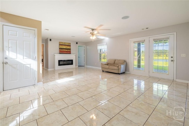 9 Sweetwater Ct, Savannah, GA 31419 - living area featuring a ceiling fan, a glass covered fireplace, and light tile patterned floors