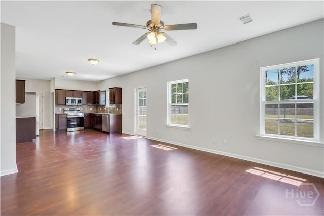 89 NE Morgan Field Blvd, Ludowici, GA 31316 - unfurnished living room with healthy amount of natural light, dark wood finished floors, and ceiling fan