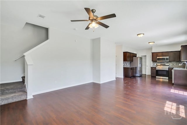 89 NE Morgan Field Blvd, Ludowici, GA 31316 - unfurnished living room featuring dark wood-type flooring, ceiling fan, and stairway