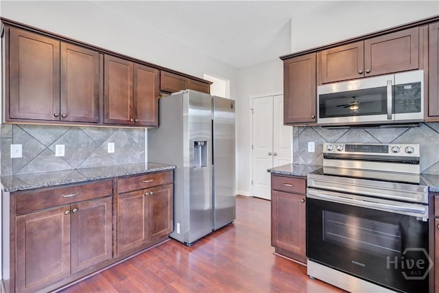 89 NE Morgan Field Blvd, Ludowici, GA 31316 - kitchen with appliances with stainless steel finishes, stone countertops, and dark wood-type flooring