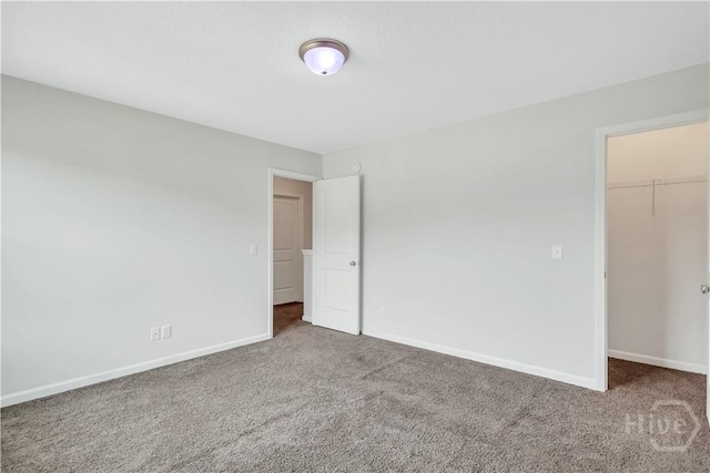 89 NE Morgan Field Blvd, Ludowici, GA 31316 - unfurnished bedroom with carpet, a walk in closet, and a closet