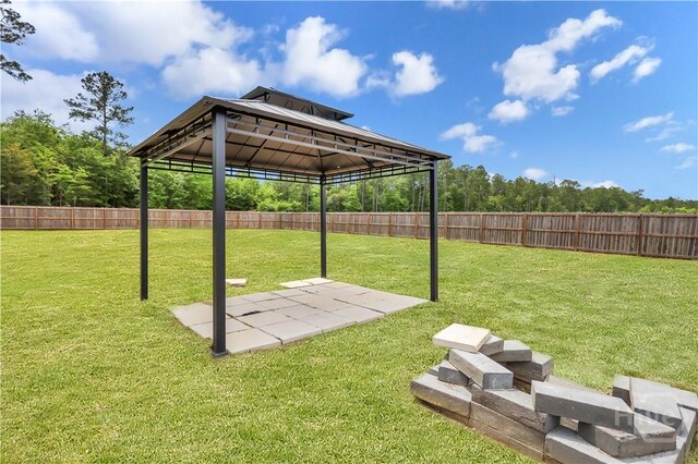 89 NE Morgan Field Blvd, Ludowici, GA 31316 - fenced backyard featuring a gazebo and a patio area
