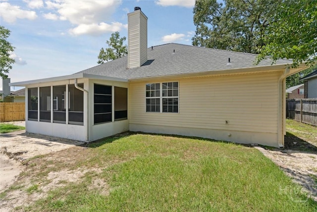 413 Roberts Way, Rincon, GA 31326 - rear view of house featuring a sunroom, a chimney, and roof with shingles