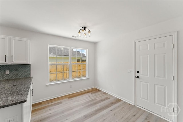 413 Roberts Way, Rincon, GA 31326 - unfurnished dining area with a chandelier and light wood-style flooring