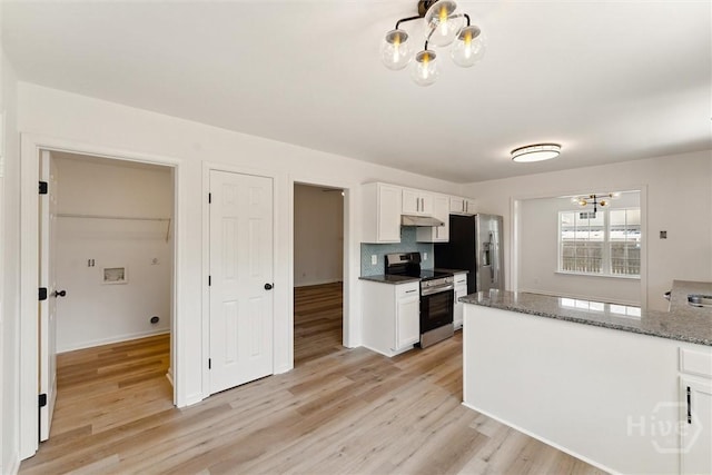 413 Roberts Way, Rincon, GA 31326 - kitchen featuring stainless steel appliances, a chandelier, under cabinet range hood, and white cabinetry