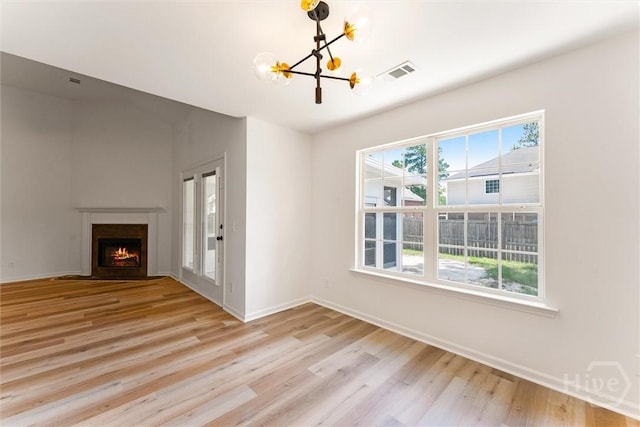 413 Roberts Way, Rincon, GA 31326 - unfurnished living room featuring a chandelier, light wood-type flooring, and a fireplace with flush hearth