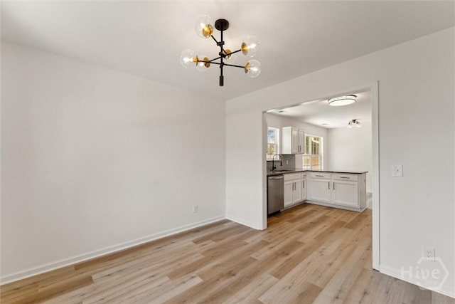 413 Roberts Way, Rincon, GA 31326 - kitchen with dishwasher, a chandelier, light wood-style floors, white cabinets, and dark countertops
