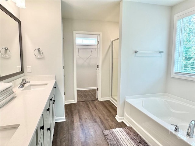 134 Melody Dr, Pooler, GA 31322 - bathroom with healthy amount of natural light, a walk in closet, and wood finished floors