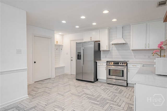 9 Bowline Ct, Savannah, GA 31411 - kitchen with appliances with stainless steel finishes, custom exhaust hood, recessed lighting, white cabinetry, and light stone countertops