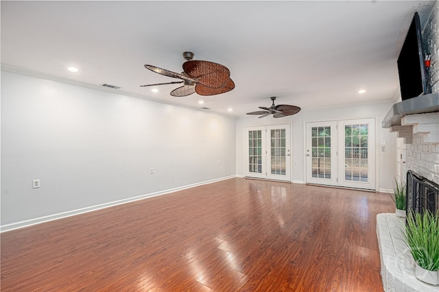 9 Bowline Ct, Savannah, GA 31411 - unfurnished living room featuring a ceiling fan, a brick fireplace, wood finished floors, crown molding, and recessed lighting