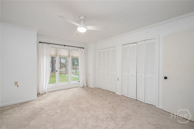 9 Bowline Ct, Savannah, GA 31411 - unfurnished bedroom featuring ornamental molding, two closets, carpet floors, and a ceiling fan