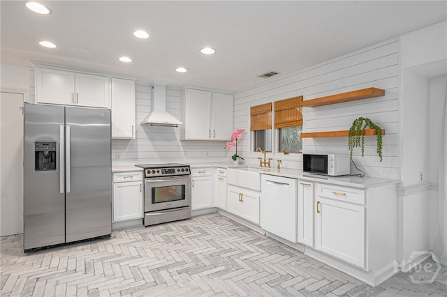 9 Bowline Ct, Savannah, GA 31411 - kitchen featuring appliances with stainless steel finishes, premium range hood, light countertops, white cabinets, and recessed lighting