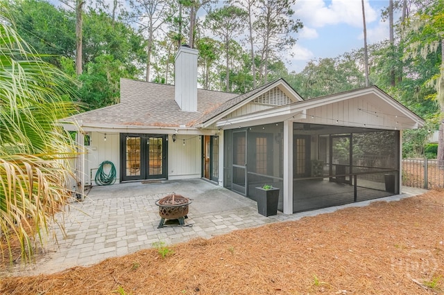 9 Bowline Ct, Savannah, GA 31411 - back of property with an outdoor fire pit, roof with shingles, a patio, a sunroom, and a chimney