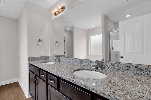 151 Guana Ln, Bloomingdale, GA 31302 - full bath featuring double vanity, wood finished floors, a shower stall, and recessed lighting