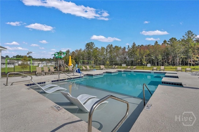 151 Guana Ln, Bloomingdale, GA 31302 - community pool featuring a patio and view of scattered trees