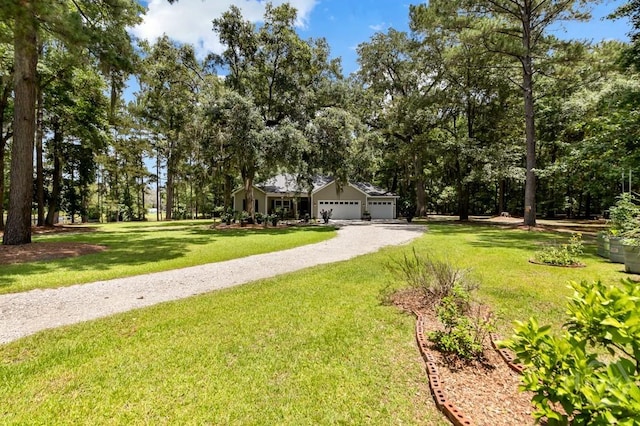287 Sandpiper Rd, Midway, GA 31320 - view of front of home with driveway, a front lawn, and a garage
