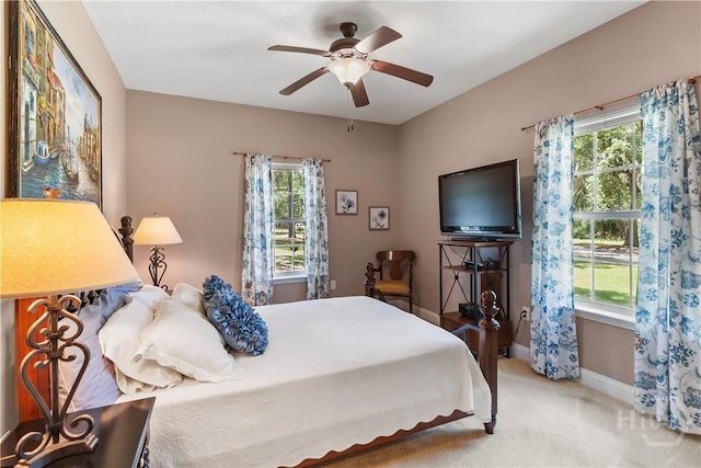 287 Sandpiper Rd, Midway, GA 31320 - bedroom with multiple windows, light colored carpet, and a ceiling fan