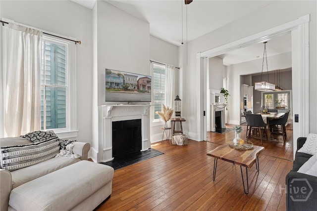 2309 Whitaker St, Savannah, GA 31401 - living area with hardwood / wood-style flooring and a fireplace