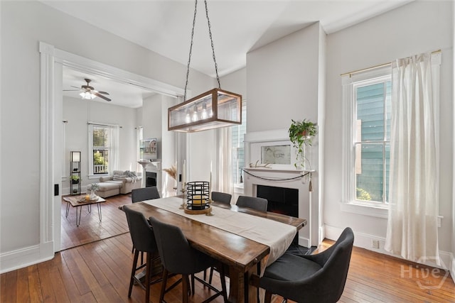 2309 Whitaker St, Savannah, GA 31401 - dining area with a fireplace, wood-type flooring, and ceiling fan