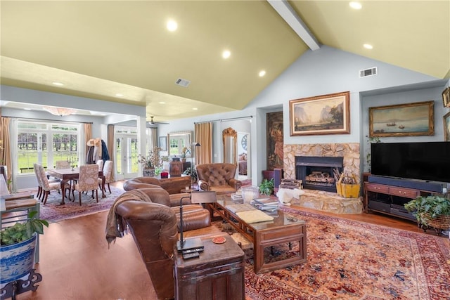 2441 Bovine Rd, Sylvania, GA 30467 - living room with beamed ceiling, high vaulted ceiling, wood finished floors, recessed lighting, and a fireplace