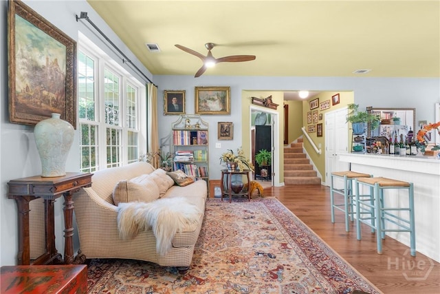 2441 Bovine Rd, Sylvania, GA 30467 - living room with wood finished floors, a ceiling fan, and stairway