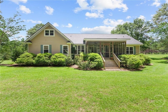 2441 Bovine Rd, Sylvania, GA 30467 - back of property featuring a sunroom, a lawn, and roof with shingles
