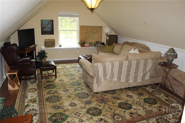 2441 Bovine Rd, Sylvania, GA 30467 - living area featuring lofted ceiling, a wainscoted wall, and wood finished floors