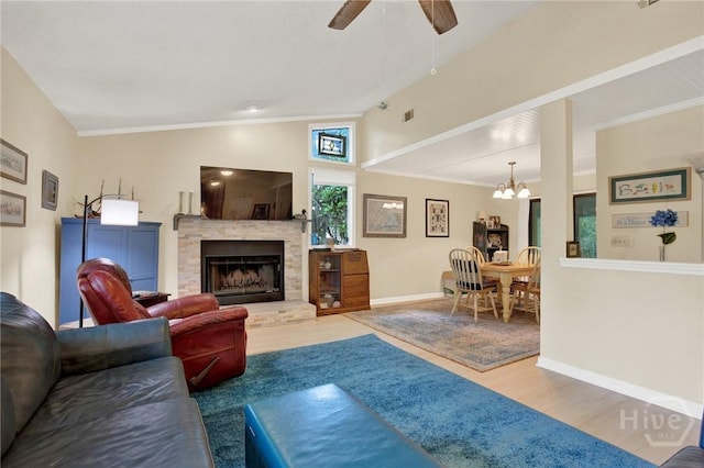 119 Catalina Dr, Tybee Island, GA 31328 - living area with wood finished floors, a ceiling fan, a fireplace with raised hearth, vaulted ceiling, and a chandelier