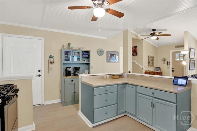 119 Catalina Dr, Tybee Island, GA 31328 - kitchen with range with gas stovetop, a ceiling fan, light wood-style floors, open floor plan, and ornamental molding