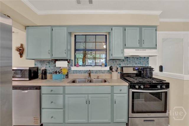 119 Catalina Dr, Tybee Island, GA 31328 - kitchen featuring appliances with stainless steel finishes, under cabinet range hood, light countertops, tasteful backsplash, and crown molding