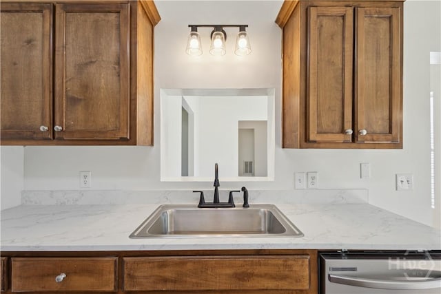 25 SE Cutters Gap, Ludowici, GA 31316 - kitchen with dishwasher, brown cabinetry, and light stone counters