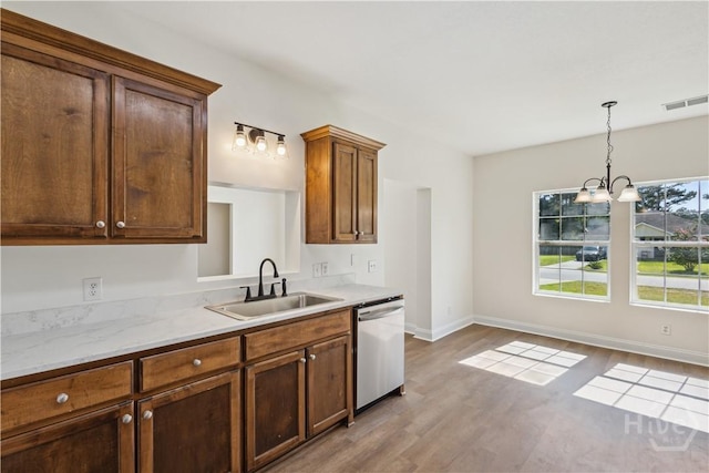25 SE Cutters Gap, Ludowici, GA 31316 - kitchen with dishwasher, wood finished floors, and hanging light fixtures