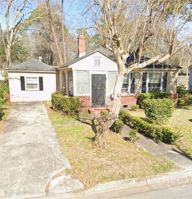 1222 NE 36th St, Savannah, GA 31404 - bungalow-style house featuring brick siding, driveway, and a chimney