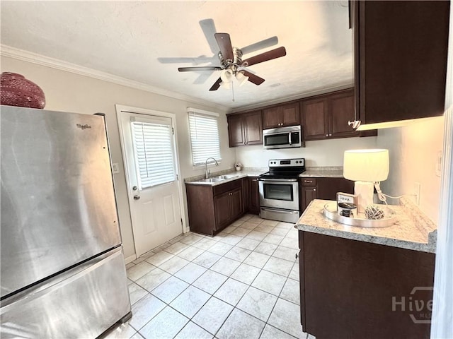 2210 Mosley St, Savannah, GA 31404 - kitchen featuring stainless steel appliances, dark brown cabinetry, light countertops, a ceiling fan, and ornamental molding