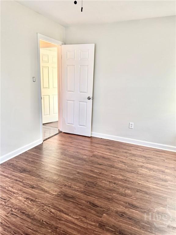 2210 Mosley St, Savannah, GA 31404 - empty room featuring dark wood-style floors and baseboards