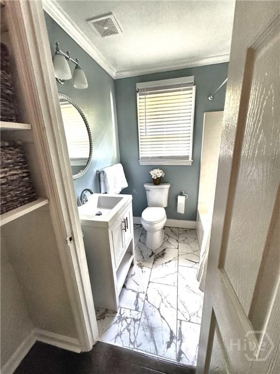 2210 Mosley St, Savannah, GA 31404 - full bathroom featuring vanity, marble finish floors, crown molding, washtub / shower combination, and a textured ceiling