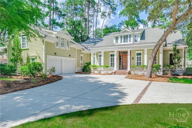 83 Waterway Dr, Savannah, GA 31411 - view of front of house with covered porch, concrete driveway, and a garage