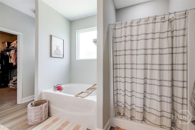 106 Cobbleton Dr, Rincon, GA 31326 - full bathroom with a bath, a shower with curtain, wood finished floors, and a walk in closet