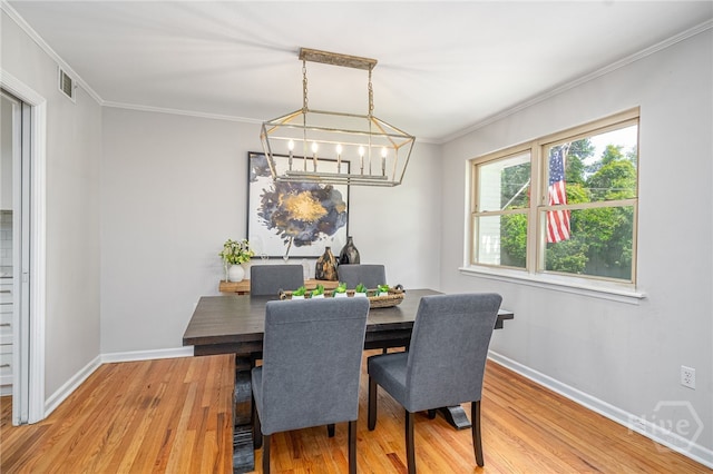 397 Hunt Dr, Savannah, GA 31406 - dining room with wood finished floors, a chandelier, and crown molding