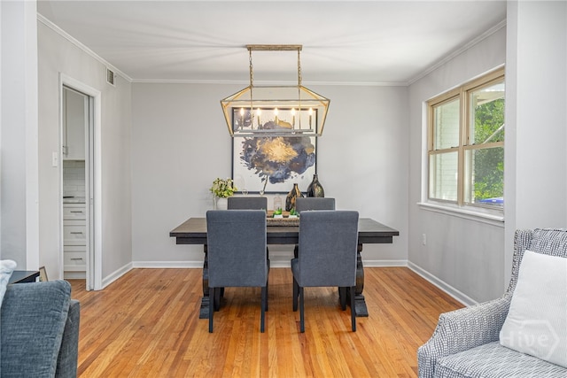 397 Hunt Dr, Savannah, GA 31406 - dining space featuring light wood-style floors, a chandelier, and crown molding